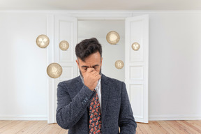 Frustrated man surrounded by coins