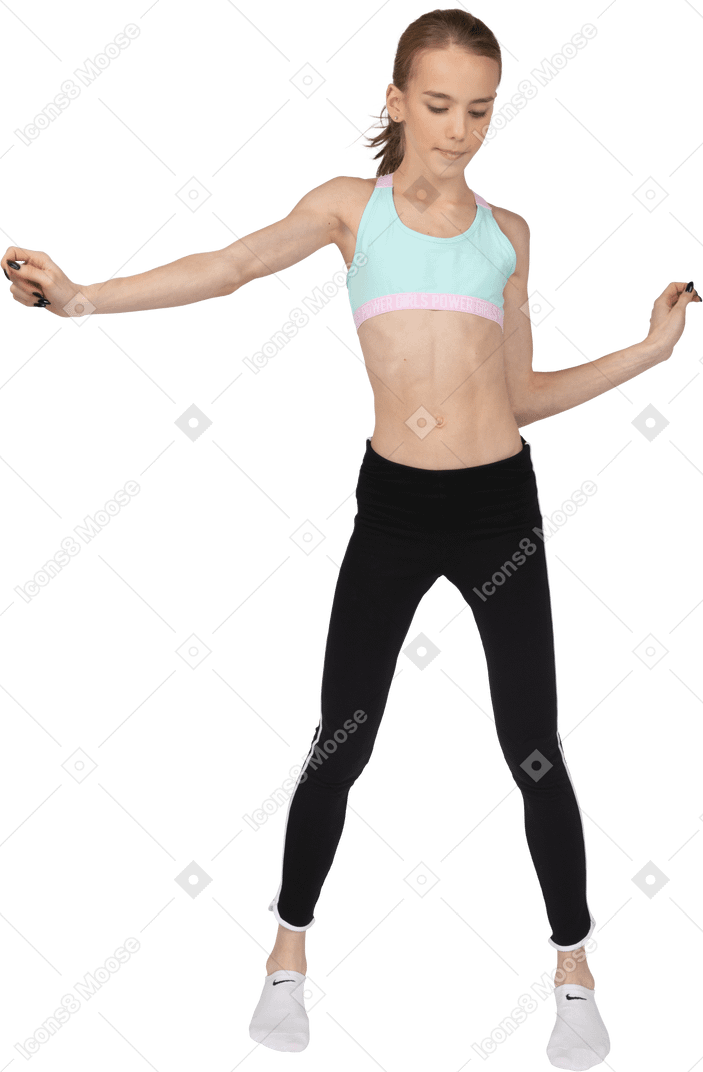 Front view of a teen girl in sportswear outstretching hand while dancing
