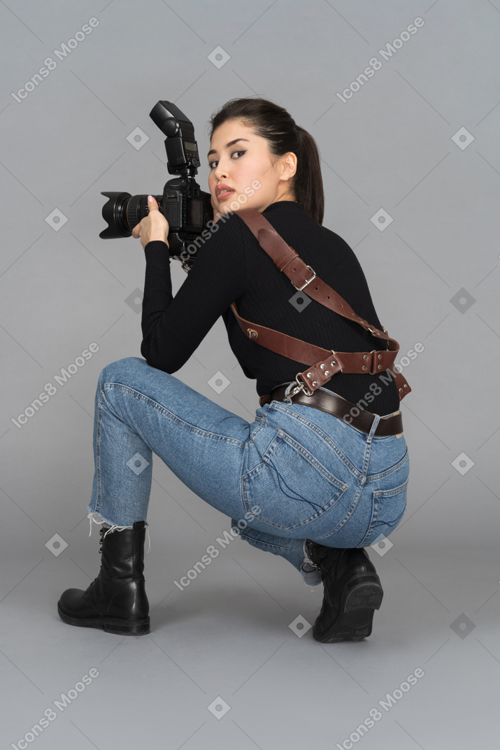 Young woman turning around while squatting on haunches