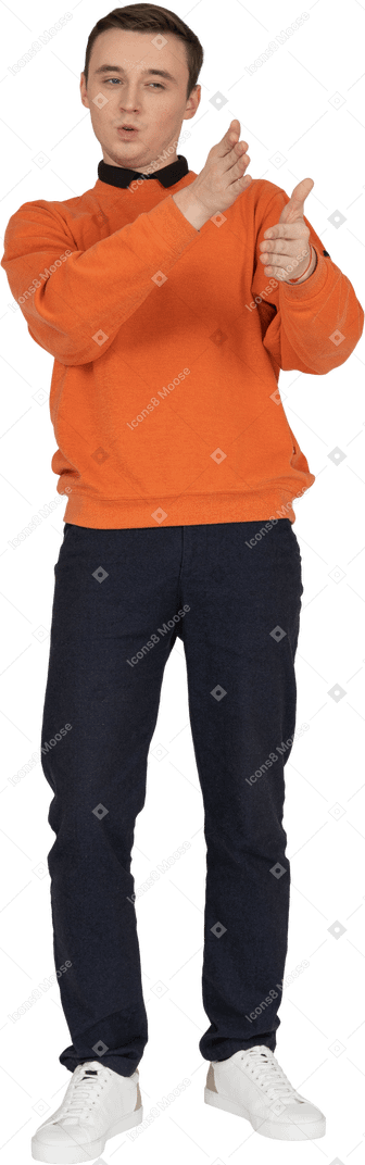 Young man in orange sweatshirt standing