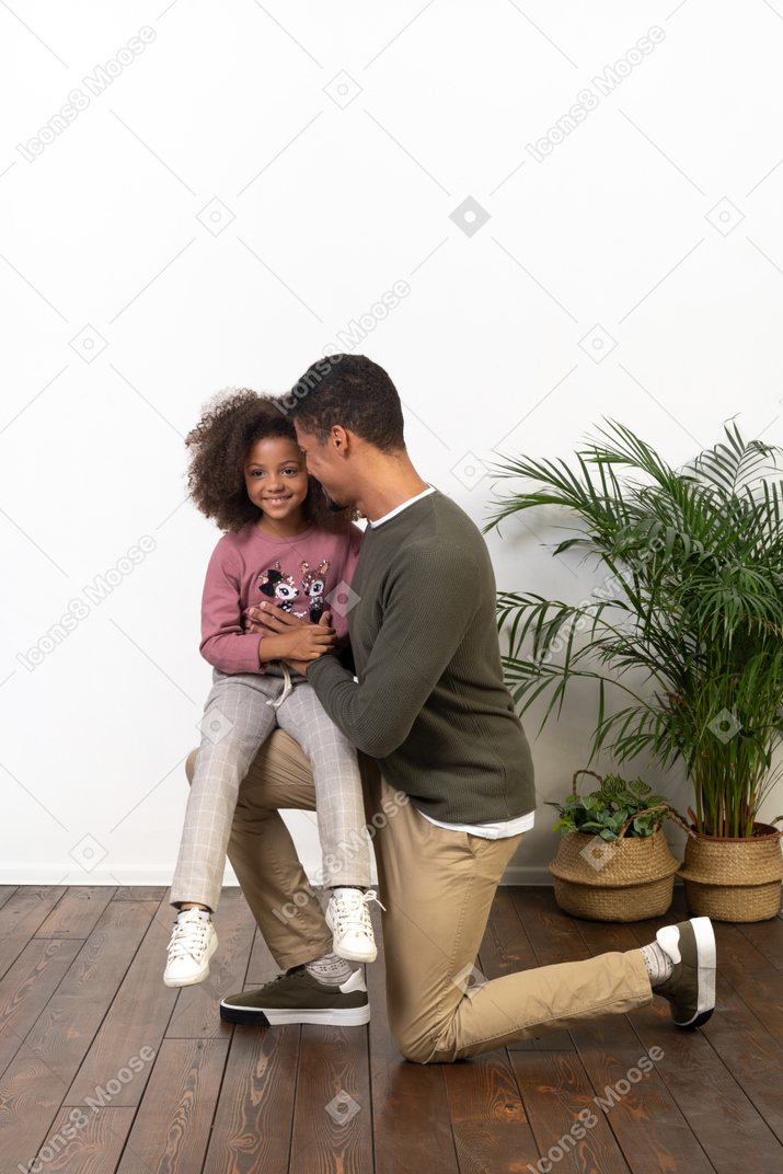 Young man on a knee with his daughter
