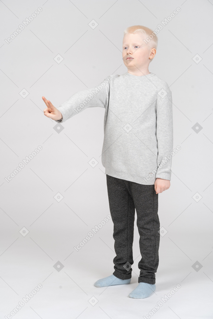Little boy making peace sign