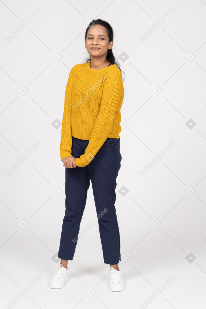 Front view of a cute girl in casual clothes looking at camera