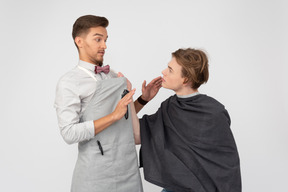 A young barber and his client