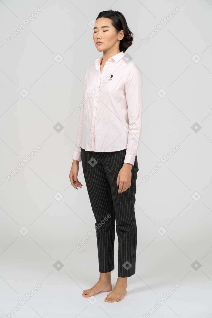 Female office worker with closed eyes standing still
