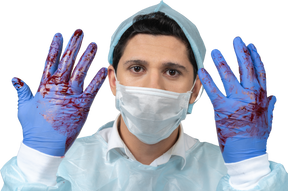 Doctor with gloves covered in blood