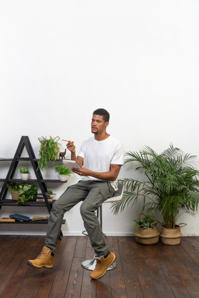 Good looking young man sitting on a chair