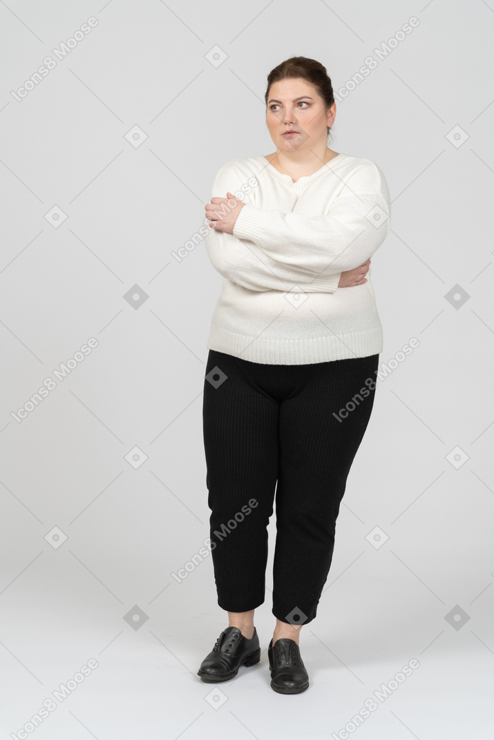 Plump woman in casual clothes keeping arms crossed