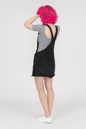 Full length portrait of an unrecognizable woman holding her head