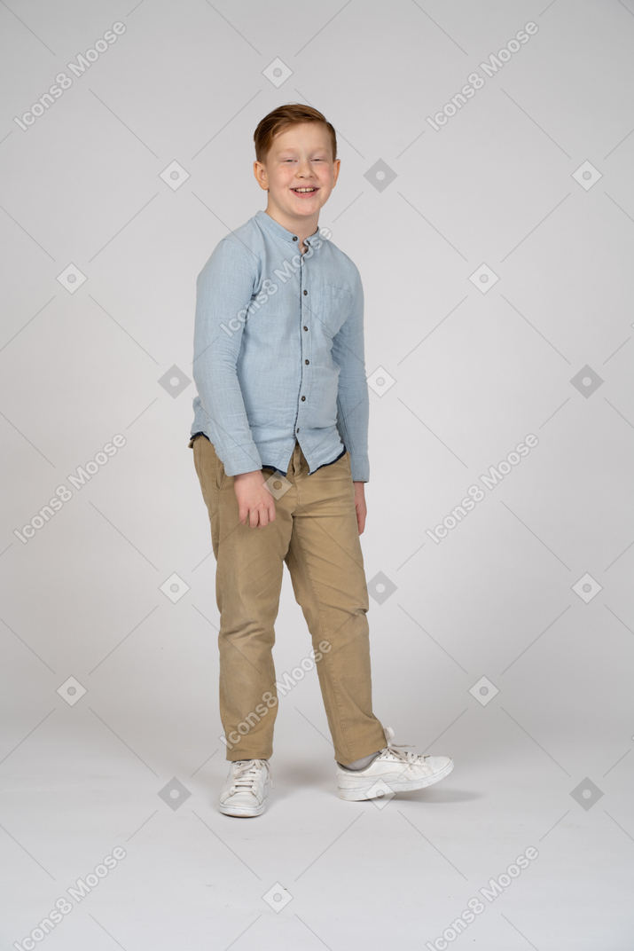 Front view of a happy boy walking