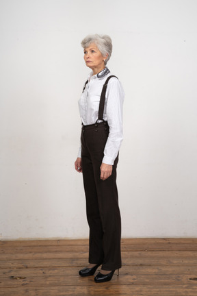 Side view of a confident old female dressed in office clothes
