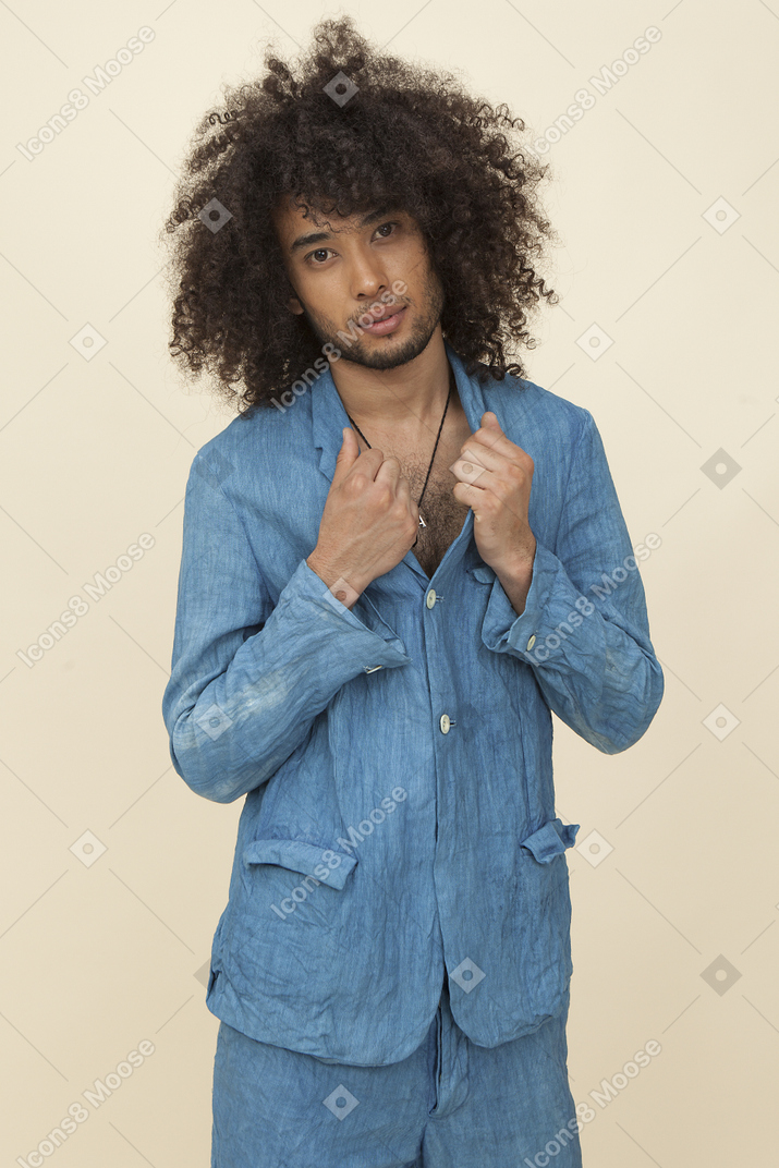 Afroman mit dem großen lockigen haar, das den kragen seiner denimjacke hält