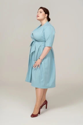 Front view of a woman in blue dress looking up