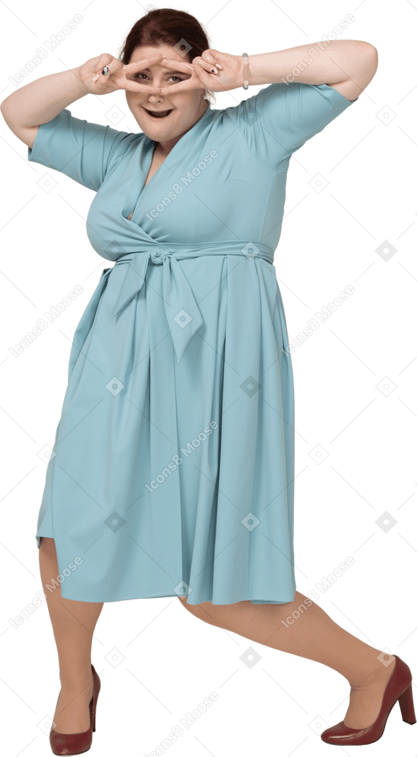 Front view of a woman in blue dress showing v signs