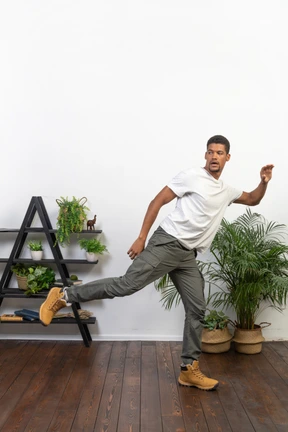 Handsome athletic man posing on the background of the apartment