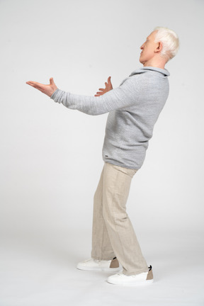 Side view of a man standing with open arms