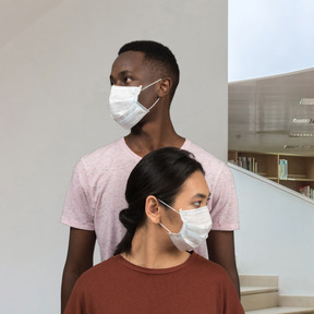 A man and a woman wearing face masks