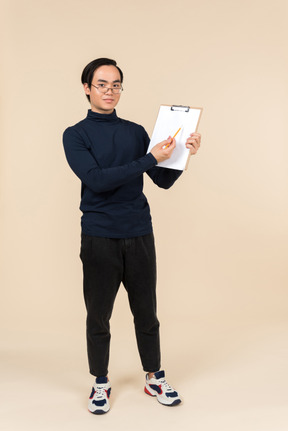 Young asian man holding a clipboard