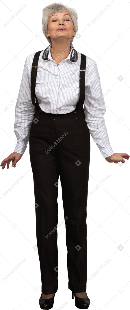 Front view of an old glad female in office clothes bending down and grimacing