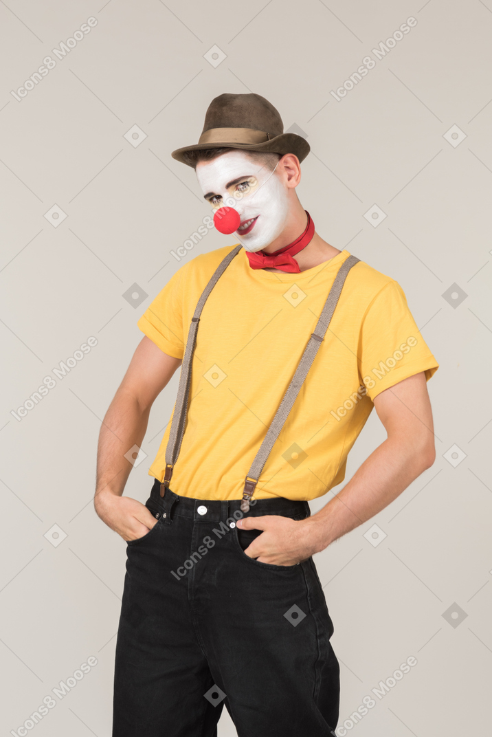 Male clown looking into camera and holding hands in pockets