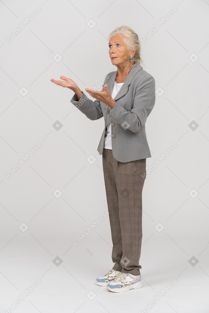 Side view of an old lady in suit explaining something