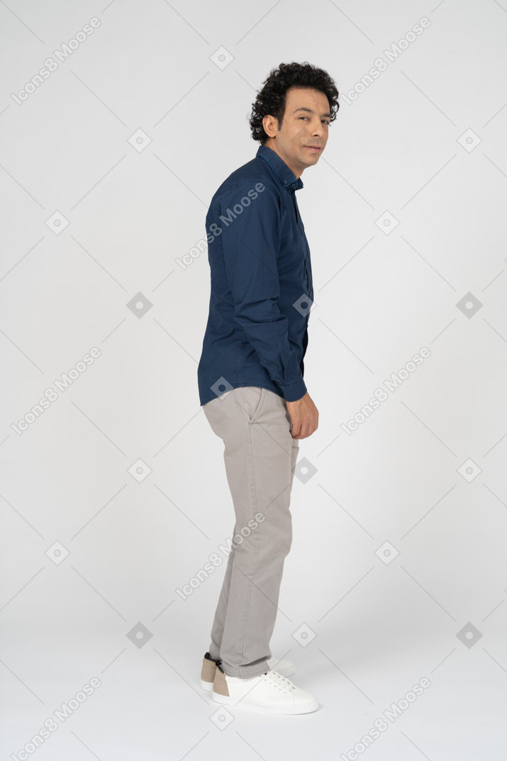 Side view of a man in casual clothes looking at camera