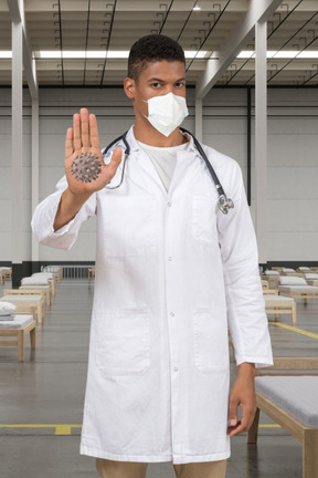 Doctor in face mask stopping coronavirus in a hospital