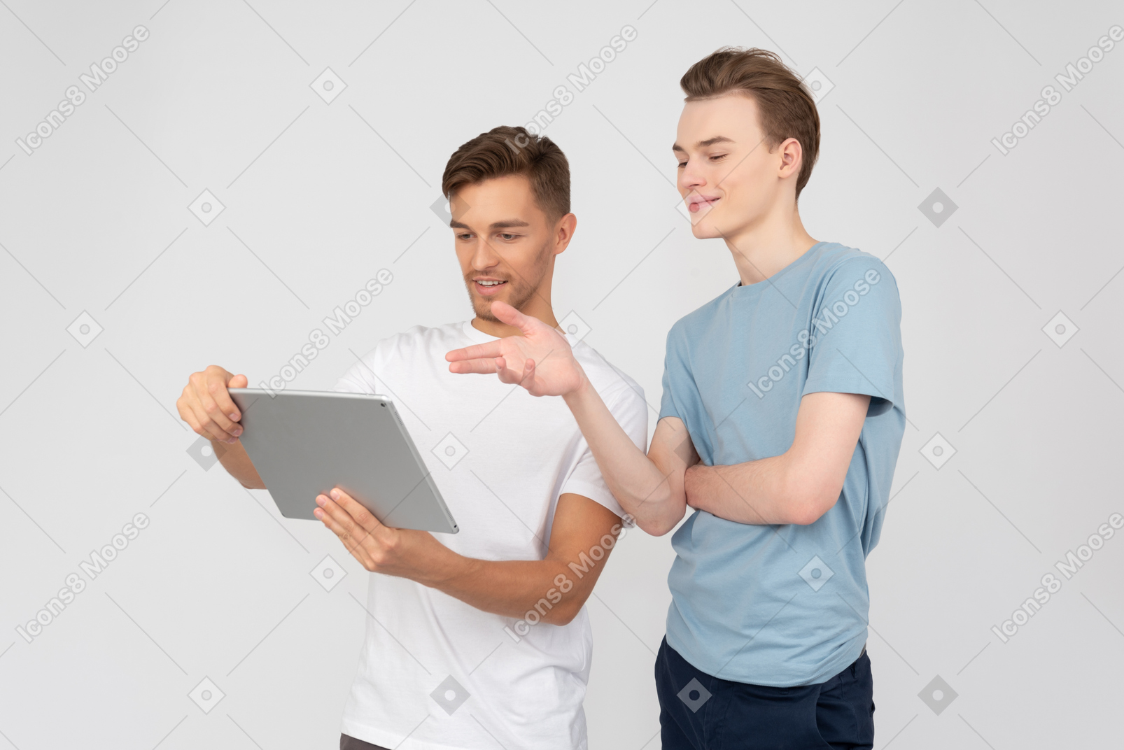 Brothers looking at tablet and discussing it