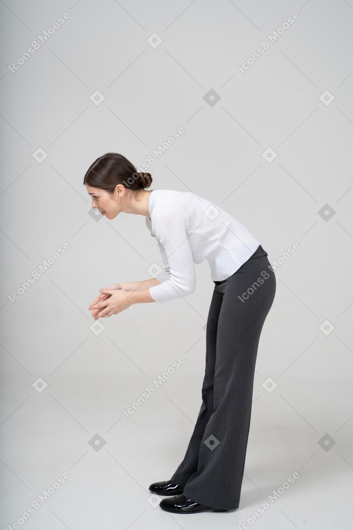 Side view of a woman bending down and explaining something to someone