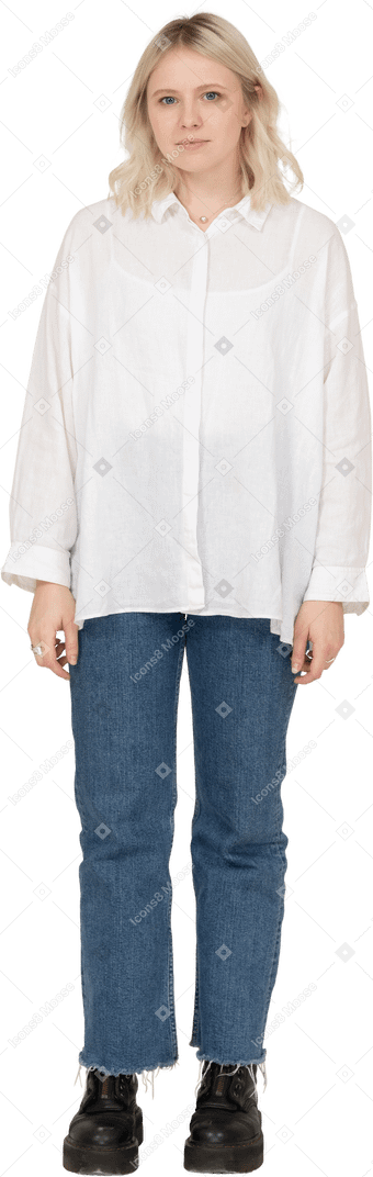 Front view of a cute blonde female in casual clothes looking at camera