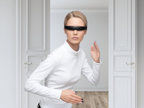 A woman in futuristic glasses standing in a robot position