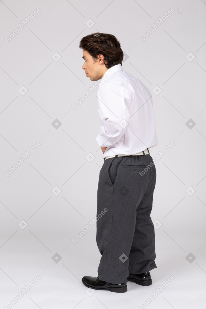 Side view of man touching stomach