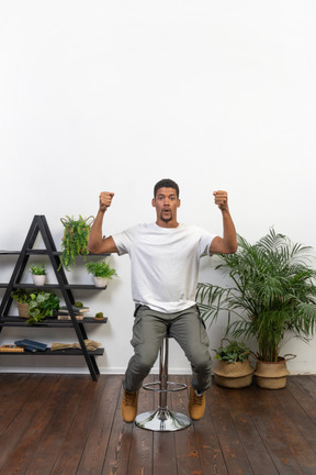 Good looking young man sitting on a chair