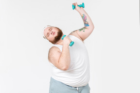 Big guy in sportswear singing using hand weights