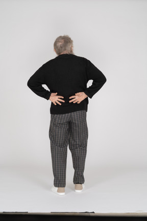 Back view of old man with hands behind back