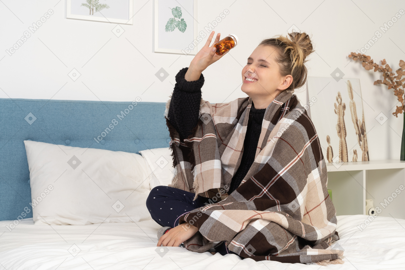 Side view of an ill young lady in pajamas with pills wrapped in checked blanket in bed