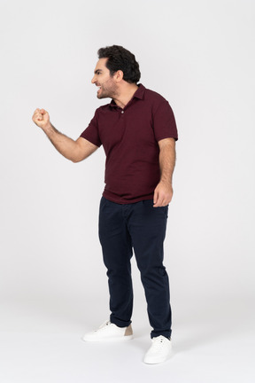 Side view of man shaking his fist