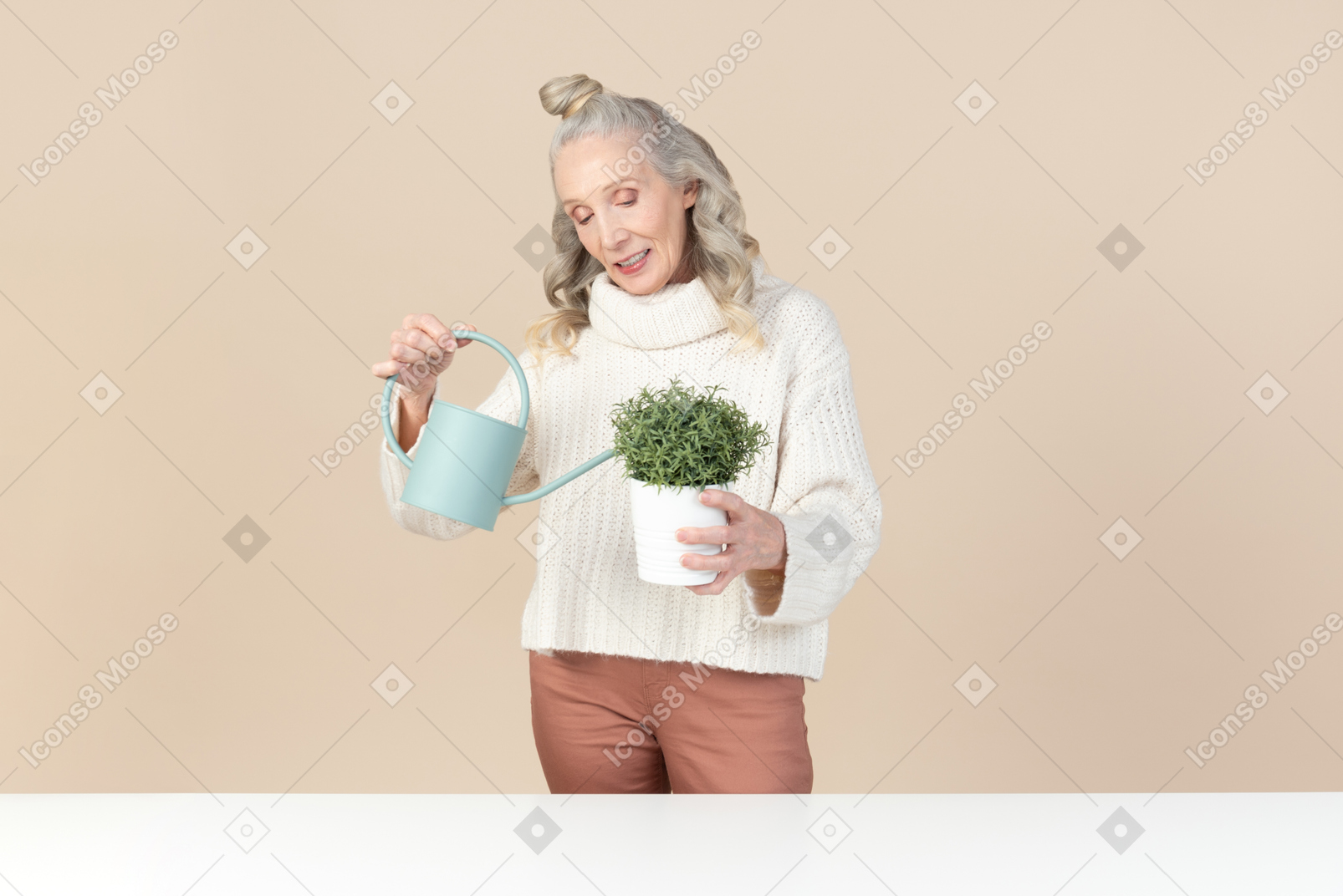 Old woman watering plant