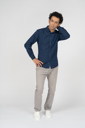 Front view of a man in casual clothes wondering