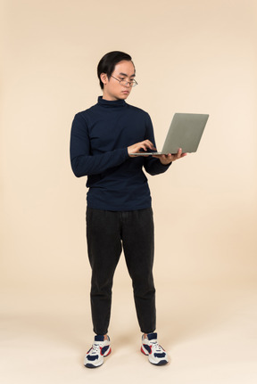 Young asian man presenting a laptop