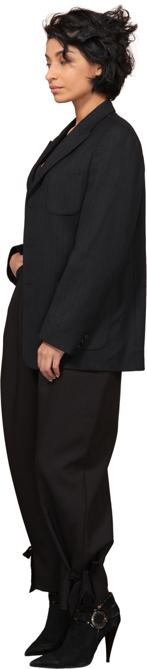 Three-quarter view of a sleepy businesswoman dressed in a black suit