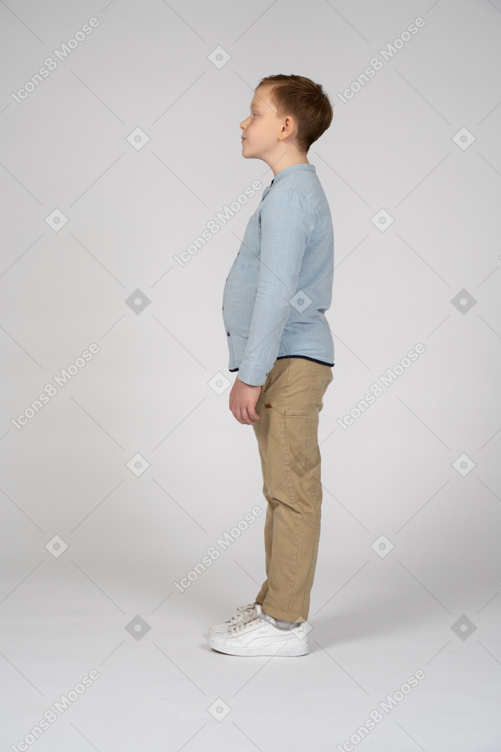 Boy standing in profile