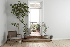 Salle blanche avec des plantes en pot menant à un espace extérieur