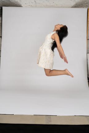 Woman in beautiful dress jumping