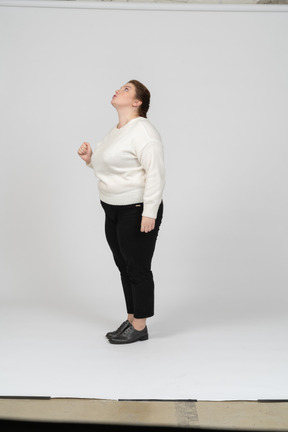 Side view of an impressed plus size woman in casual clothes