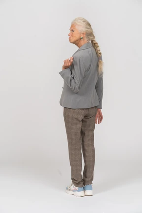Rear view of an old lady in suit