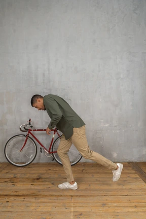 Side view of a man tripping and almost falling forward