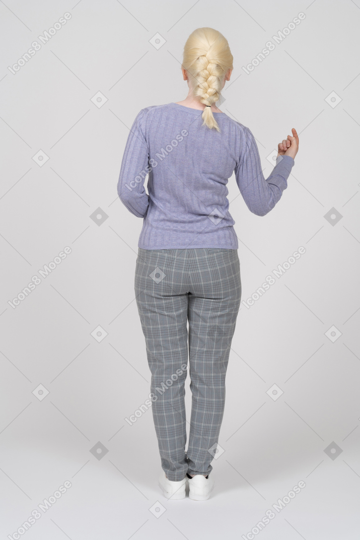 Back view of a woman beckoning someone
