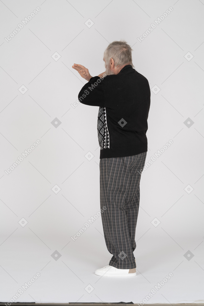 Rear view of old man with hands crossed