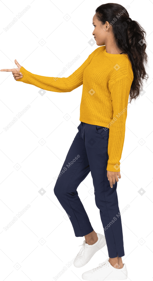 Side view of a girl in casual clothes pointing with finger
